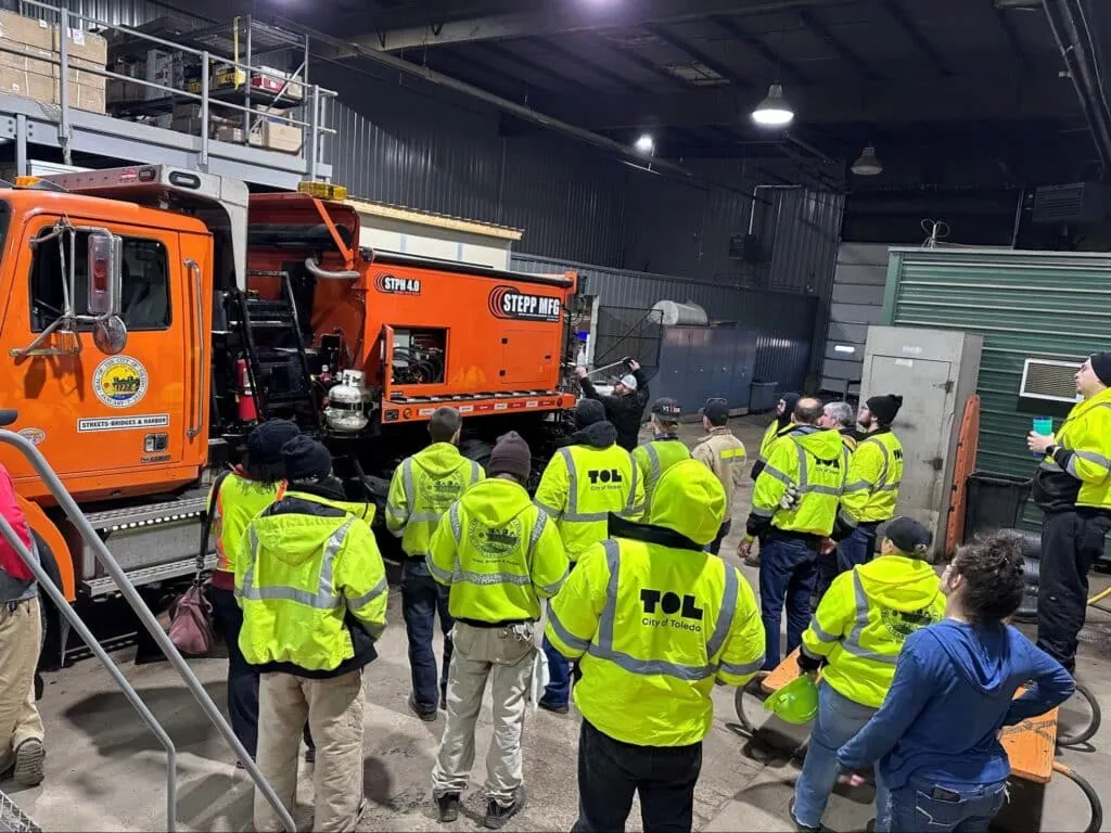Hot box operator trainees learn equipment operations in a warehouse environment.