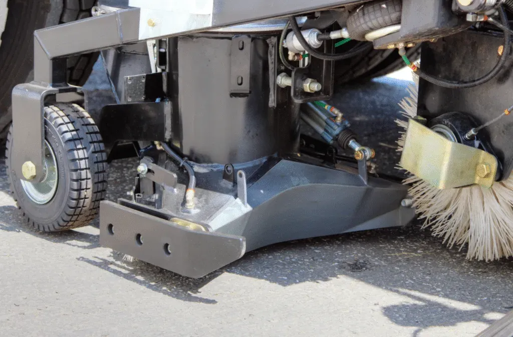 Close-up of a street sweeper cleaning machine component for optimal performance and efficiency.