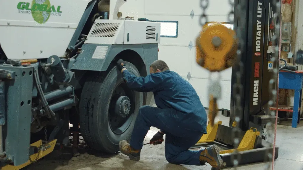 Brown Equipment Company mechanic working on a truck in a service center.