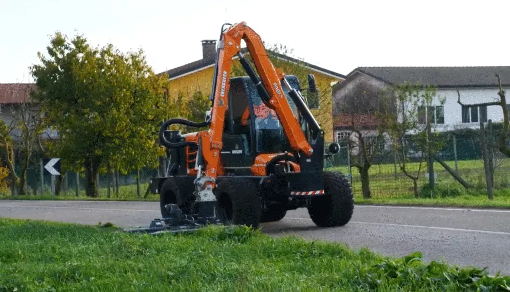 Compact roadside maintenance vehicle enhancing visibility by trimming grass and vegetation.