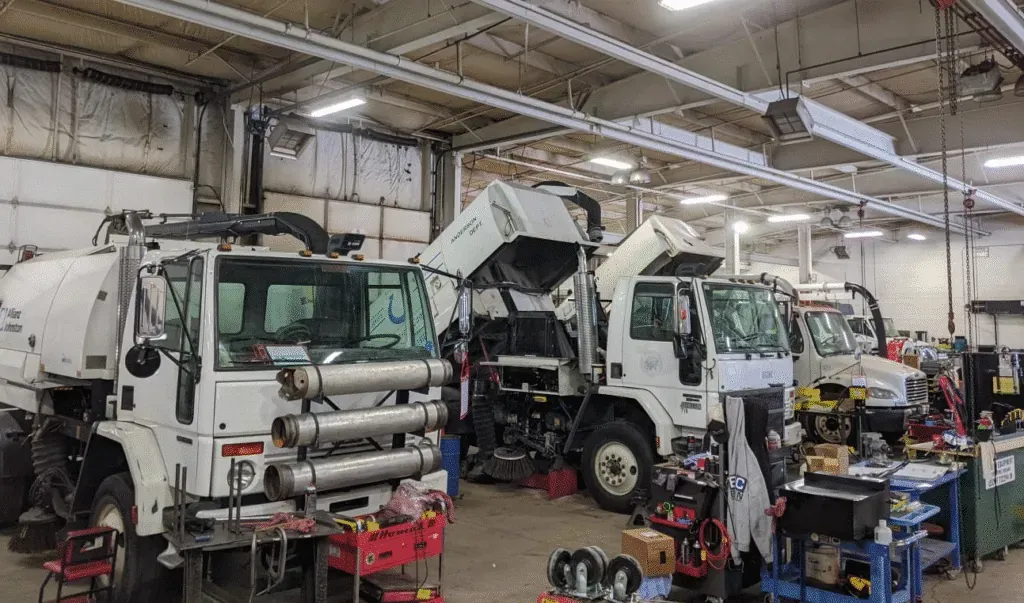 trucks receiving routine maintenance in a service workshop.