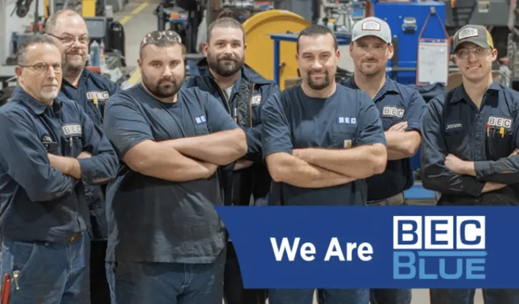 BEC Blue Team members proudly showcasing teamwork and commitment in their workspace.